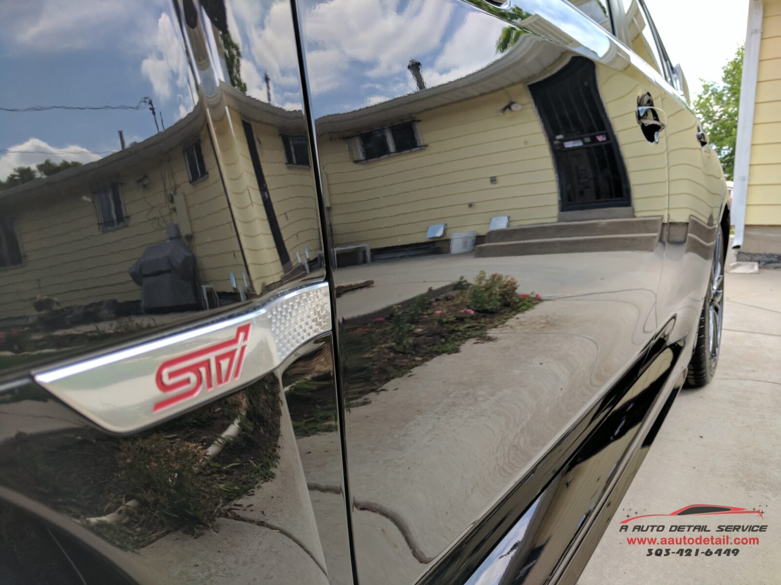 A car is reflected in the side of a house. Due to our Premier Ceramic Coating in Brighton, CO